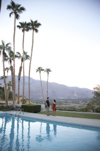 Couple enjoying cocktails by pool with panaromic view